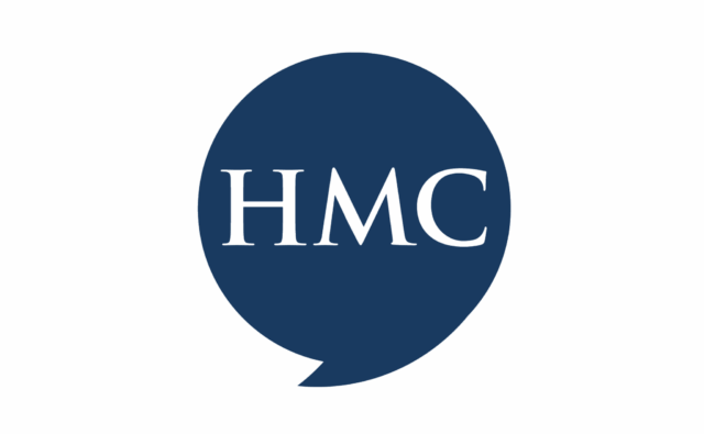 A dark navy blue stylized speech bubble containing the letters HMC in a white serif font.