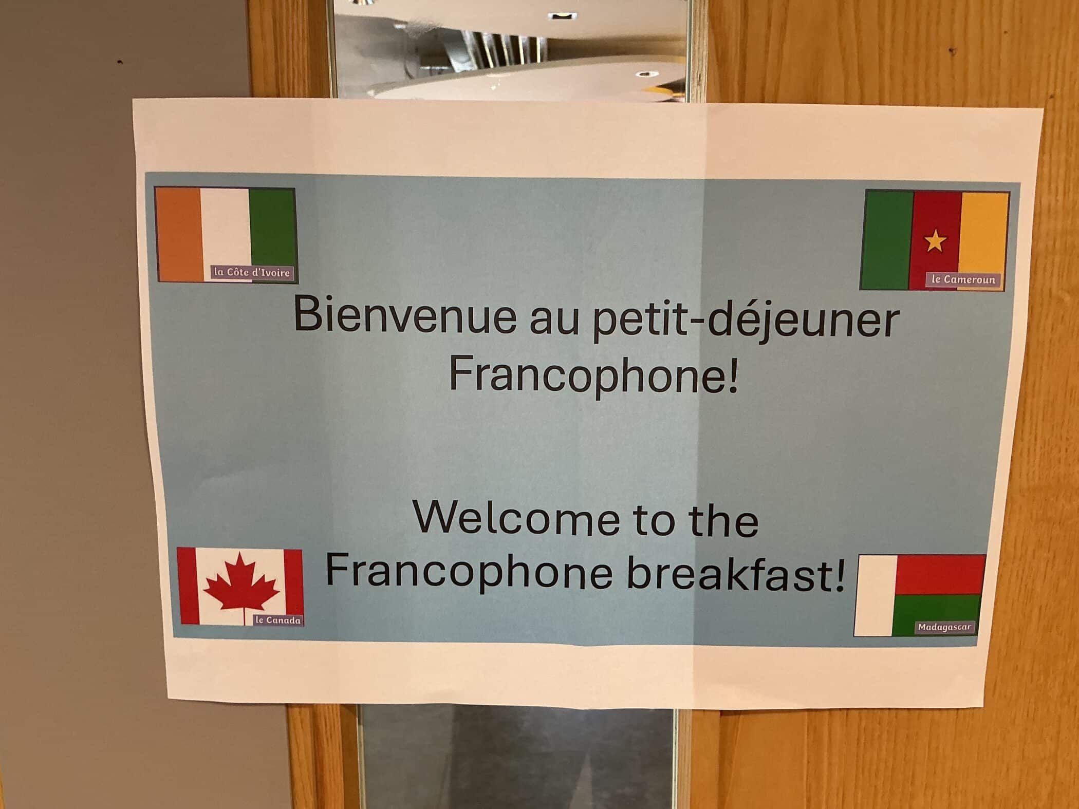 A bilingual sign on a door that reads 
