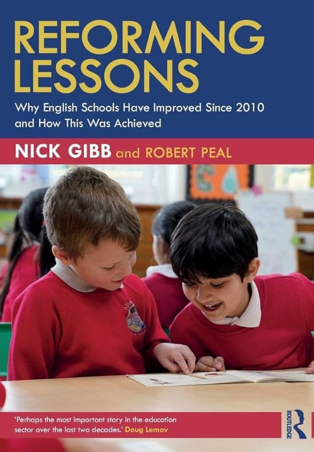 Book cover of “Reforming Lessons: Why English Schools Have Improved Since 2010 and How This Was Achieved” by Nick Gibb and Robert Peal. The cover shows two young boys in red school uniforms smiling and reading a book together at a classroom table. A quote at the bottom from Doug Lemov reads, “Perhaps the most important story in the education sector over the last two decades.” Published by Routledge.
