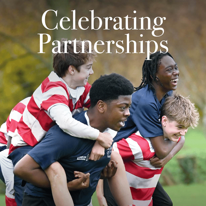 A group of school students are outdoors, smiling and laughing while playing a piggyback race. Two students in dark blue sports uniforms are carrying teammates in red and white striped rugby shirts. The background shows a grassy field with trees. The text reads “Celebrating Partnerships,” and the logo of the Independent Schools Council appears in the lower left corner. The issue number “Issue 10” is in the bottom right.
